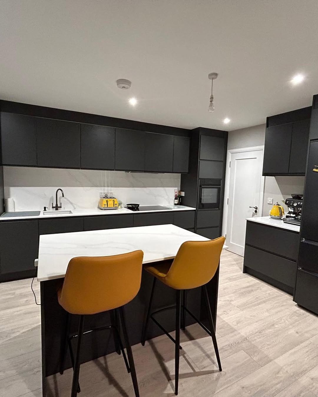 Bespoke matt-black kitchen with marble island handcrafted by Paul Costelloe Kitchens in Kilkenny
